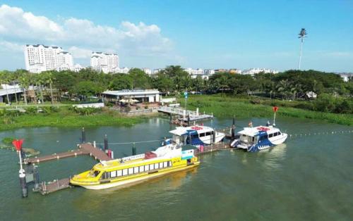 two boats are docked at a dock in the water at Swanbay - KaKa's House in Cù Lao Ong Con