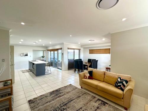a living room with a couch and a kitchen at Hideaway on Peel in Busselton