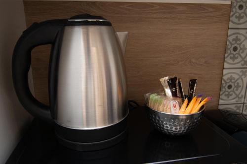 a coffee pot sitting on a table with a cup of utensils at L'Horizon des Randonneurs - Duplex avec Balcon in Les Hôpitaux-Neufs