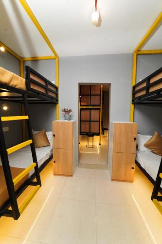a dorm room with bunk beds and a desk at Vib O Stay in Pune