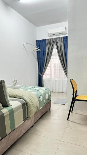 a bedroom with a bed and a chair and a window at LestariHome1, KLIA Sepang in Sepang