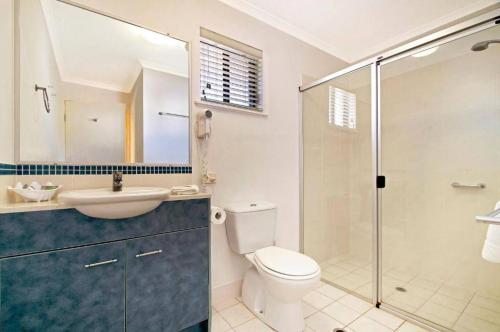 a bathroom with a toilet and a sink and a shower at Ivory Palms Resort Noosa in Noosaville