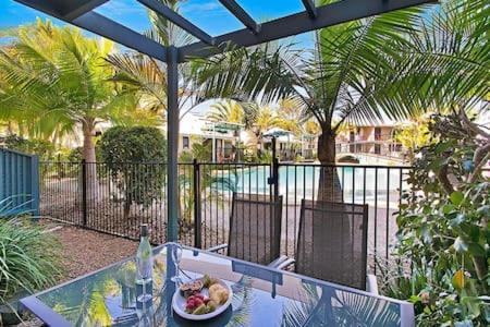 a plate of food on a table on a patio at Ivory Palms Resort Noosa in Noosaville