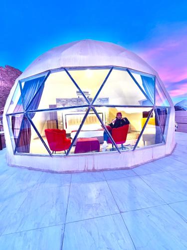 a man sitting in a room in an igloo at Rum Angel Camp in Wadi Rum