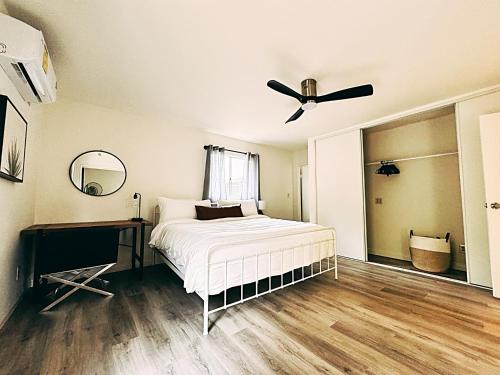 a bedroom with a bed and a desk and a ceiling fan at Pet friendly Spacious 3Bed with HUGE Back Yard in San Diego