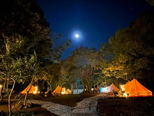 a group of tents at night with the moon at COUSCOUS Glamping Manazuru in Manazuru