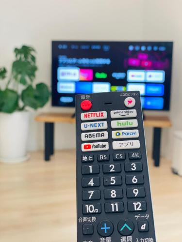 a remote control sitting in front of a tv at Naha Airport, beaches, shopping centers are nearby #NewVilla in Itoman