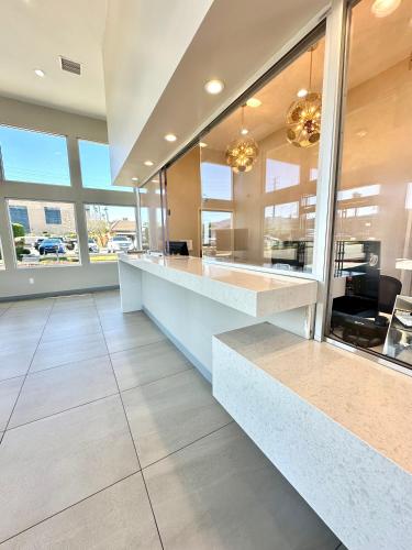 a large kitchen with a counter and large windows at Studio 6 Corona, CA West in Corona