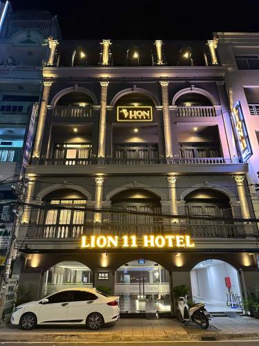 a white car parked in front of a hotel at LION 11 Can Tho Hotel in Can Tho