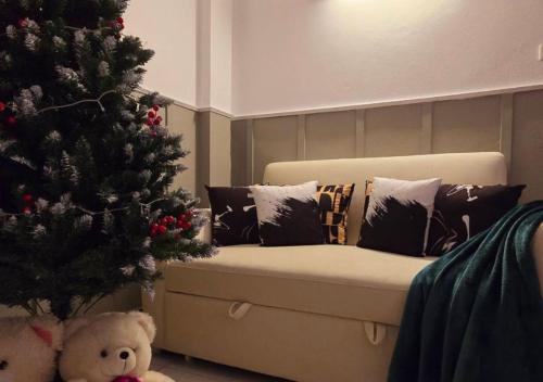 a christmas tree and a couch next to a christmas tree at SridaHouse#Near Central Festival Hat Yai in Sathani Khlong Rian