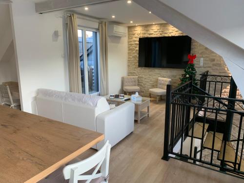 a living room with a couch and a table at Duplex vieux marché quartier historique wifi/parking in Rouen