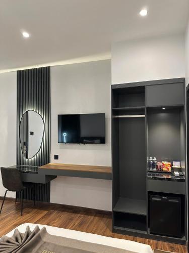 a living room with a television and a mirror at LION 11 Can Tho Hotel in Can Tho