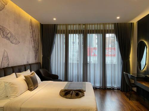 a bedroom with a bed with a hat on it at LION 11 Can Tho Hotel in Can Tho