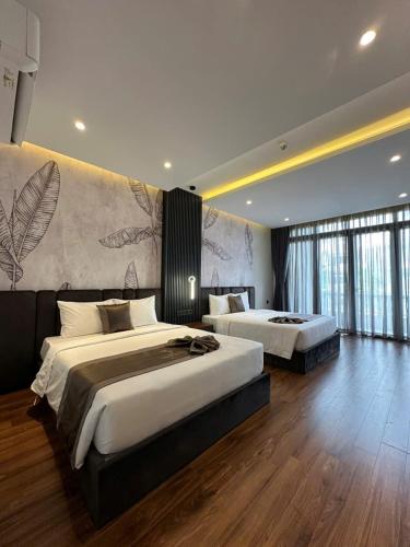 a large bedroom with two beds and a wall at LION 11 Can Tho Hotel in Can Tho