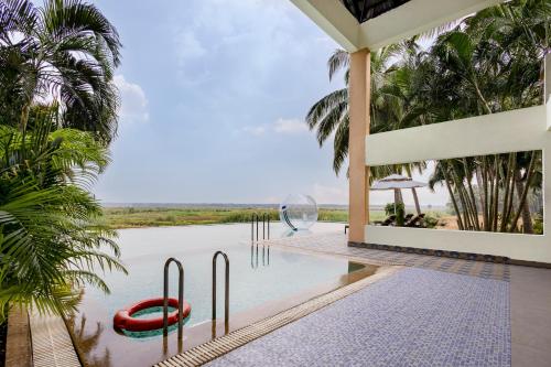 a pool in a villa with a view of the water at Sterling Palavelli Godavari in Rāzole