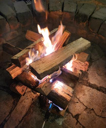 a fire pit with logs in a brick oven at Ellon Hanok Pension in Yeosu
