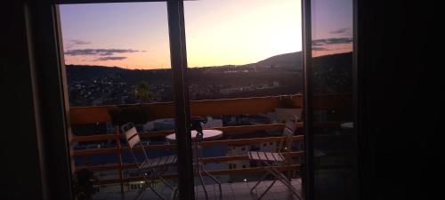 a view from a window of a balcony with chairs at Vista para a serra in Bragança