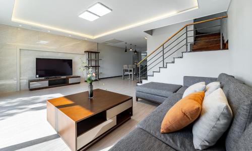 a living room with a couch and a table at Kylin Villa resort Jeju in Seogwipo