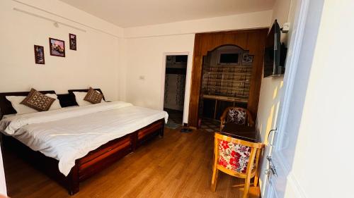 a bedroom with a bed and a television in it at Mashobra Homestay - Crignano in Mashobra