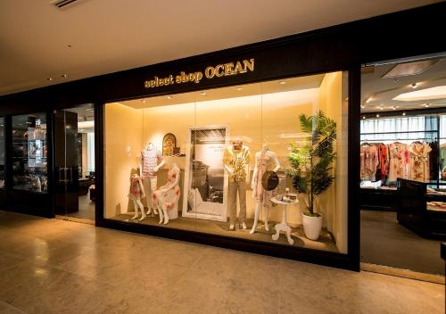 a store window of a clothing store with mannequins at Hotel Monterey Okinawa Spa & Resort in Onna