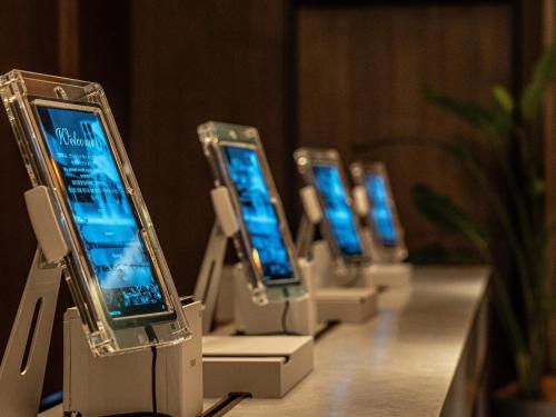 a row of cell phones on display on a table at Namba Oriental Hotel in Osaka