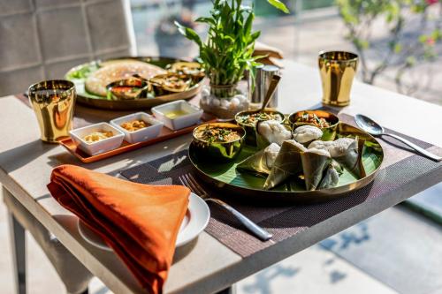 a table topped with plates of food on a table at Sterling Palavelli Godavari in Rāzole