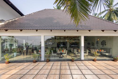 a building with a patio with tables and chairs at Sterling Palavelli Godavari in Rāzole