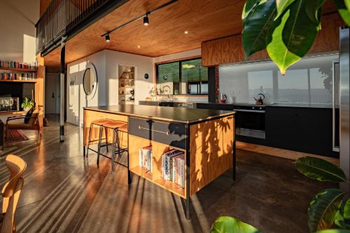 a kitchen with a large island in the middle of a room at Black Barn Escape in Nelson