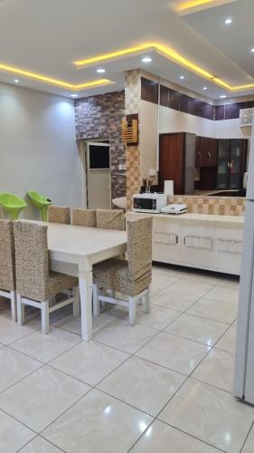 a kitchen with a table and chairs in a room at Al Moltaqua Chalet in Taif
