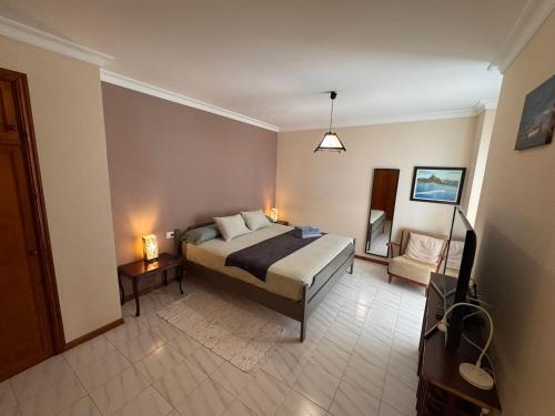 a bedroom with a bed and a chair in it at Alquilaencanarias Tabaiba vista mar in Tabaiba