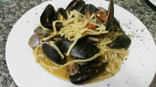 a plate of food with pasta and mussels at Albergo B&B Antica Trattoria Bacco in Circello