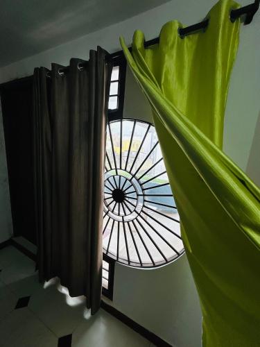 a window in a room with a curtain at Stay Confo Villa in Puducherry