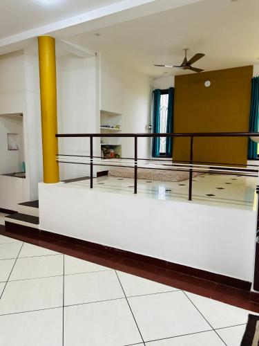a living room with a couch and a ceiling fan at Stay Confo Villa in Puducherry