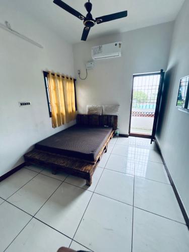 a bedroom with a bed in a room with a window at Stay Confo Villa in Puducherry