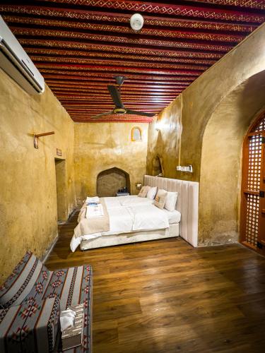 a bedroom with two beds in a large room at IHYAA Inn - نزل إحياء in Nizwa