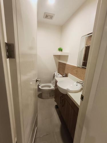 a bathroom with a toilet and a sink at Matina Enclaves 2BR with Wifi Near SM Mall in Davao City