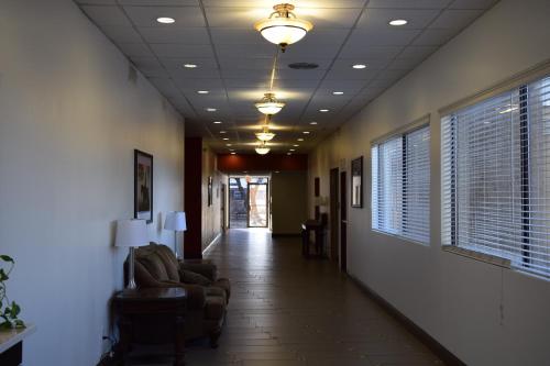 a hallway with chairs and a ceiling with lights at Baymont by Wyndham Midland Airport in Midland