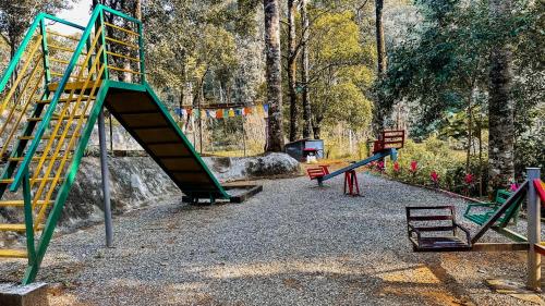 a playground with a slide in a park at Skyfall 900kandi in Meppādi