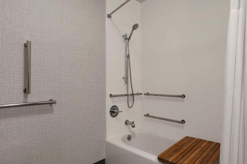 a bathroom with a shower and a sink at Hampton Inn Starkville in Starkville
