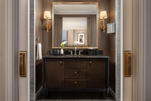 a bathroom with a sink and a mirror at Waldorf Astoria New York in New York