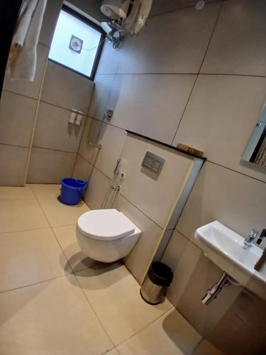 a bathroom with a toilet and a sink at MGM Whispering Meadows Yelagiri in Yelagiri
