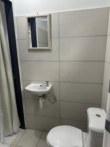 a bathroom with a sink and a toilet at Villa Nola Dos in Port-of-Spain