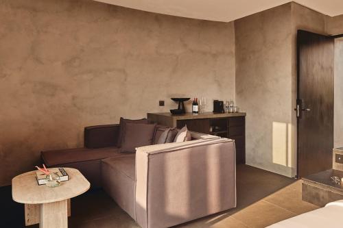 a living room with a couch and a table at Je Ne Sais Quoi Seminyak in Seminyak