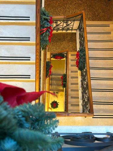 a mirror on a building with christmas wreaths at Palazzo CarpeDiem-Prato della Valle in Padova