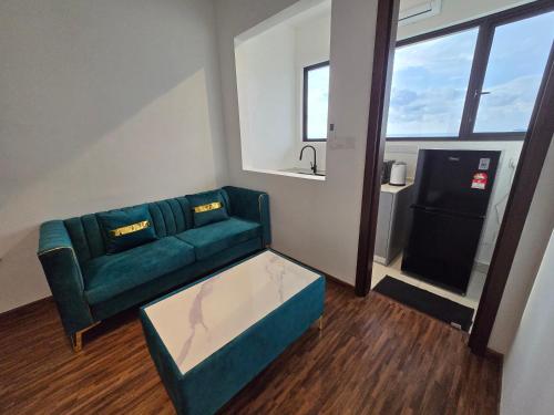 a living room with a couch and a table at K Avenue Kota Kinabalu by Merveille - Sabah in Donggongon