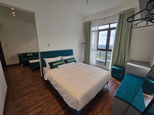 a bedroom with a bed and a large window at K Avenue Kota Kinabalu by Merveille - Sabah in Donggongon