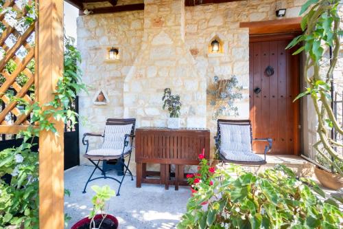 a patio with two chairs and a wooden table at Cretan Dream Studio in Heraklion