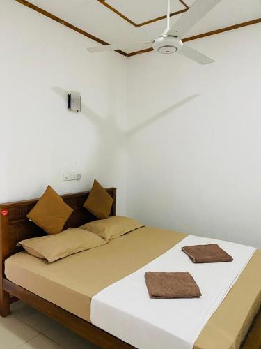 a bed with two pillows on it in a room at Sea View Resort in Galle