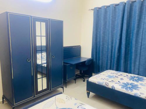 a bedroom with a desk with a computer and a bed at Modern comforts of 311 to Dubai in Ajman