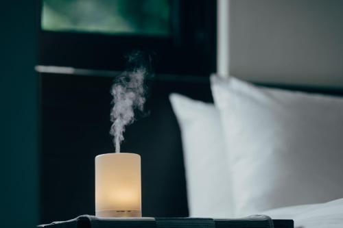 a white candle with smoke coming out of it at Adagio JinGuaShi in Jiufen